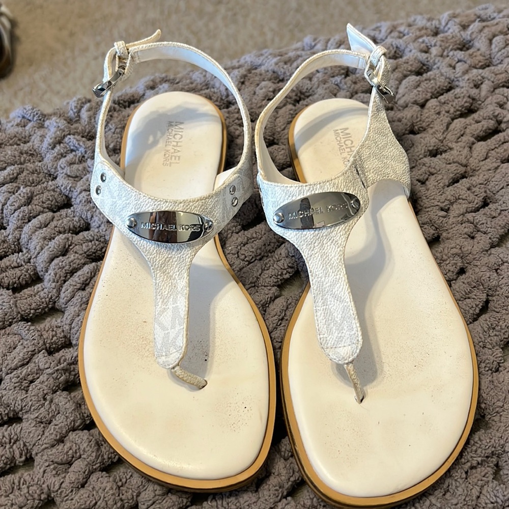White and silver Michael Kors sandals.